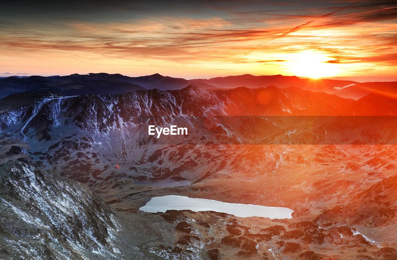 Scenic view of mountains against sky during sunset