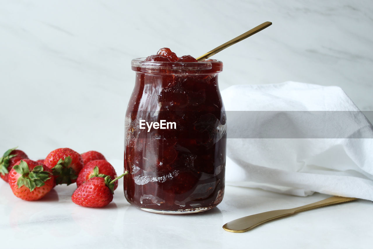 Close-up of strawberries and jam on table