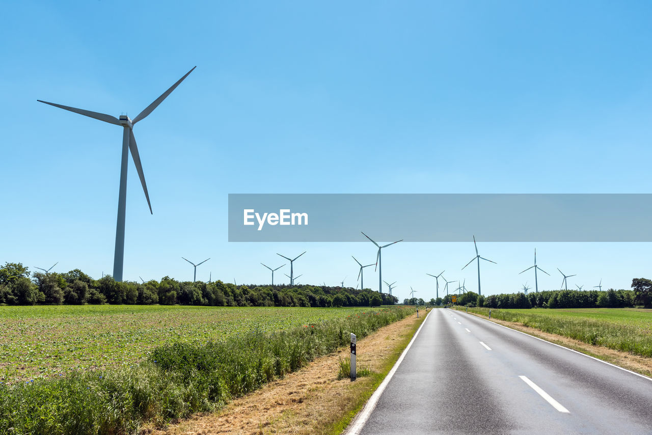 Wind power plants and a country road seen in germany