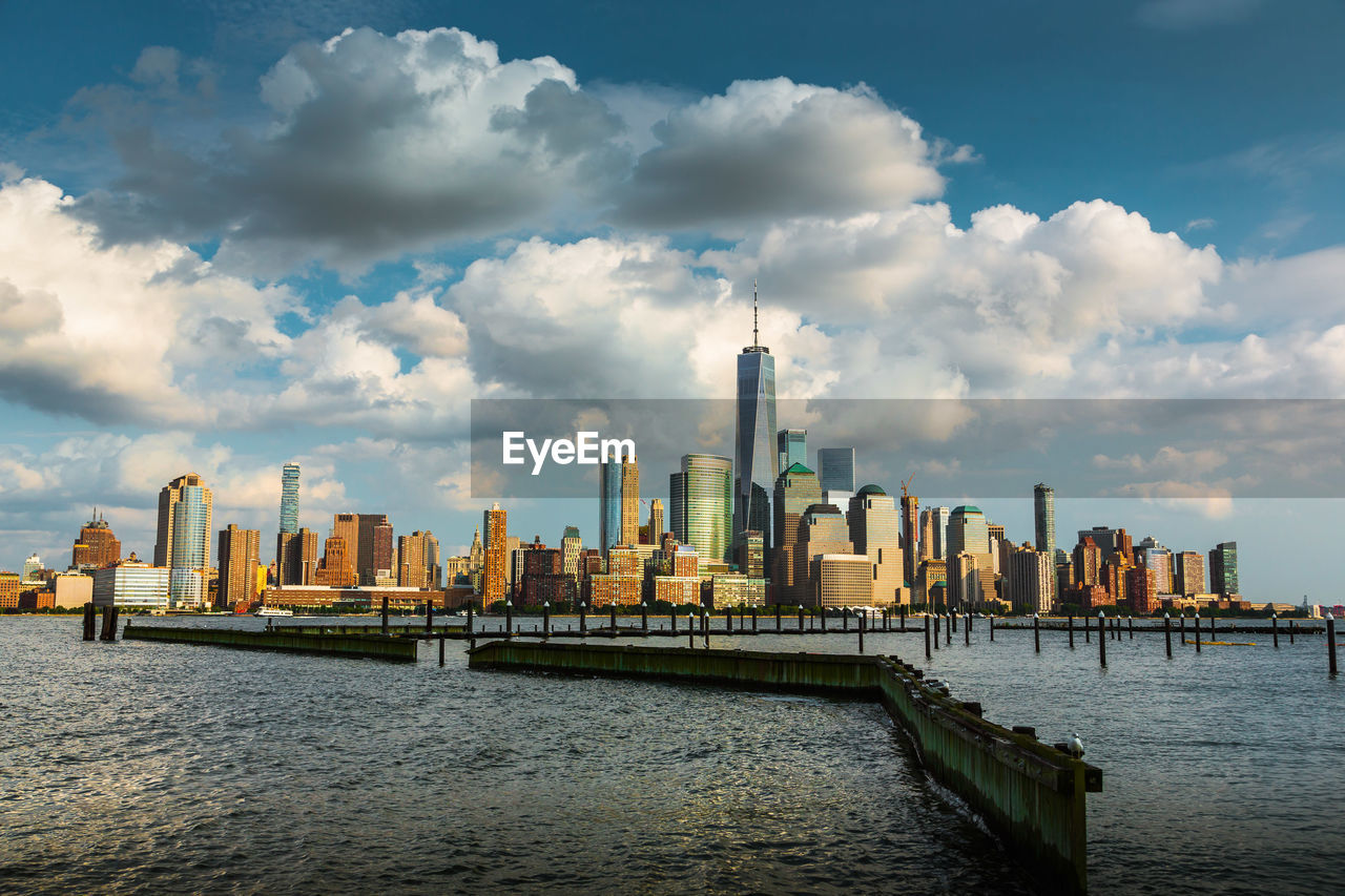 SCENIC VIEW OF RIVER AND BUILDINGS AGAINST SKY