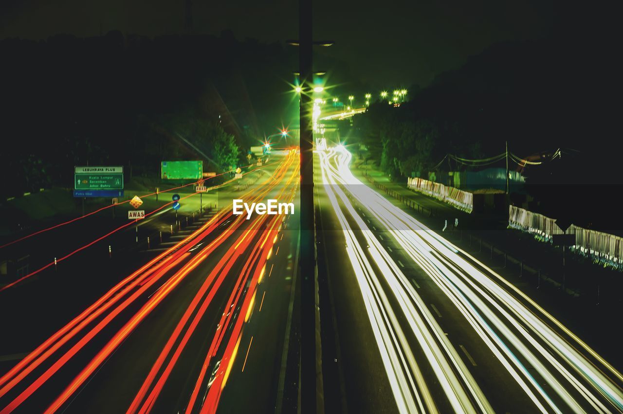 High angle view of light trails on highway at night