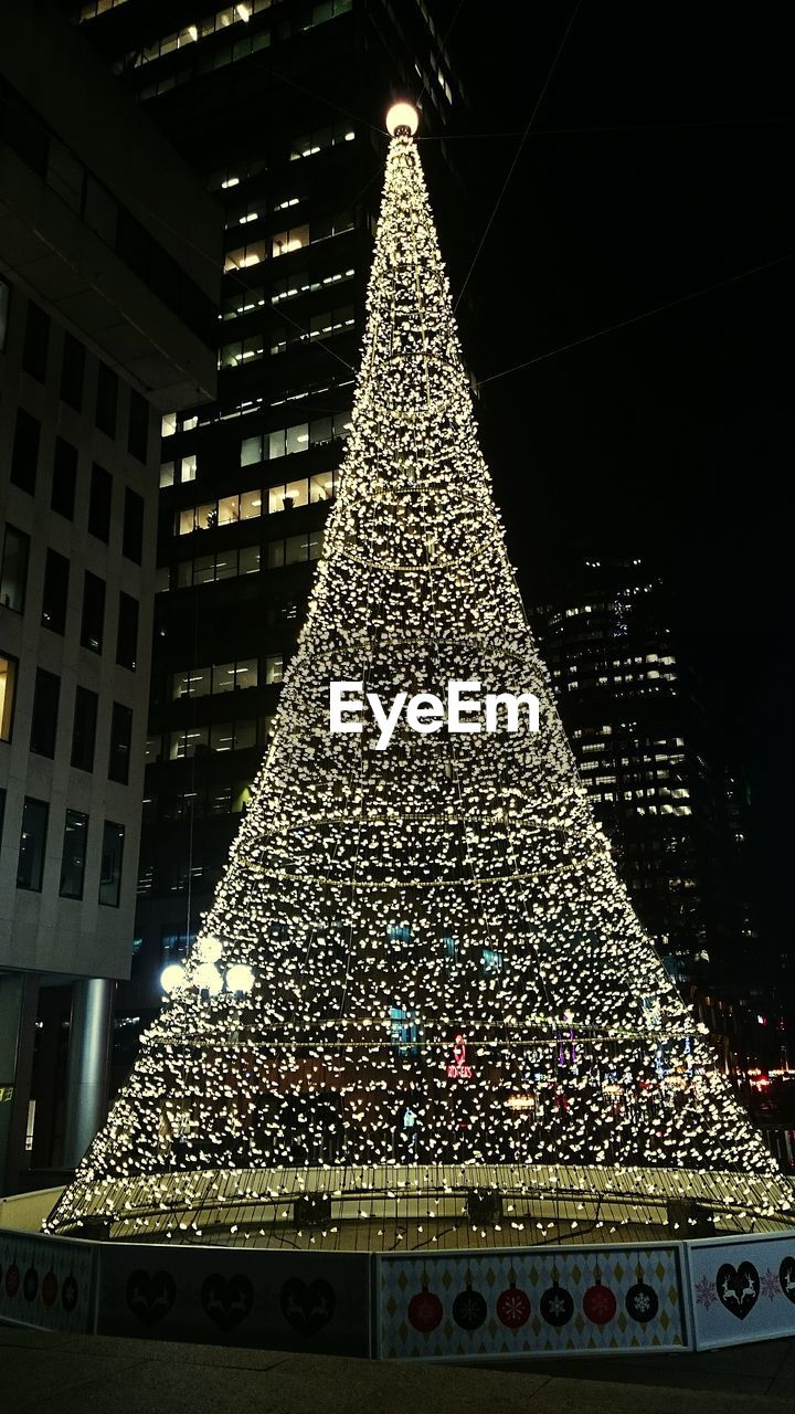 LOW ANGLE VIEW OF ILLUMINATED LIGHTS AT NIGHT