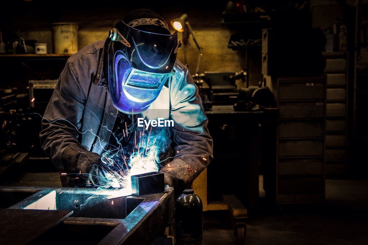 Welder welding at workshop