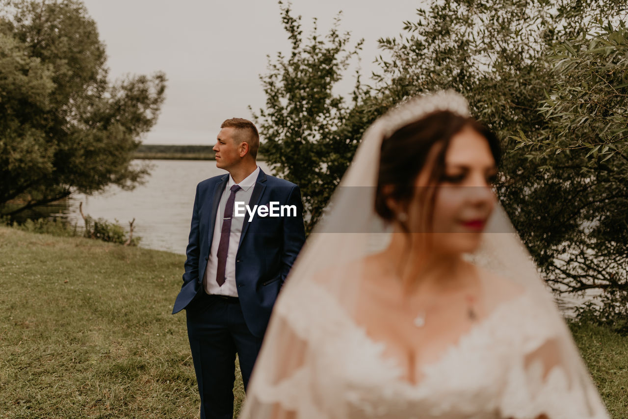 portrait of smiling couple standing in park