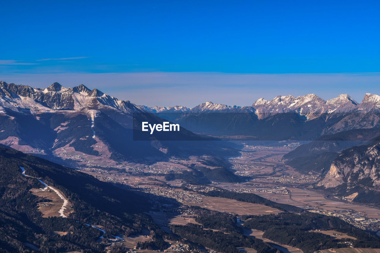 Scenic view of mountains against blue sky