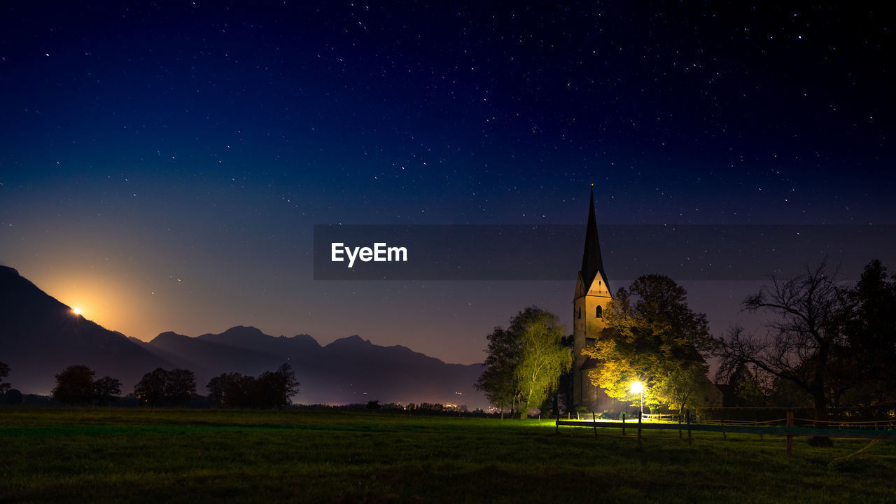 Panoramic view of illuminated church against sky at night