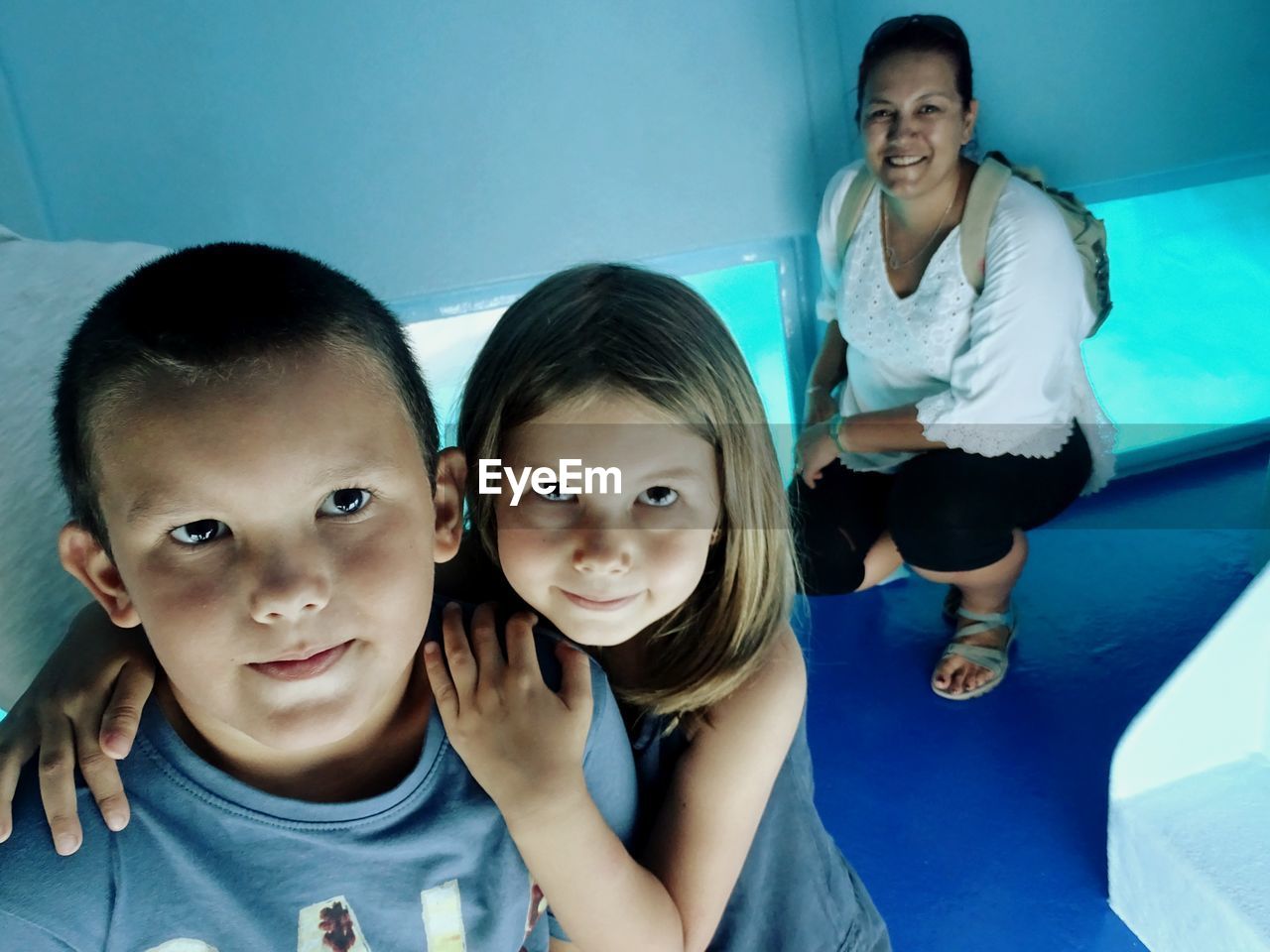 Portrait of smiling siblings with mother