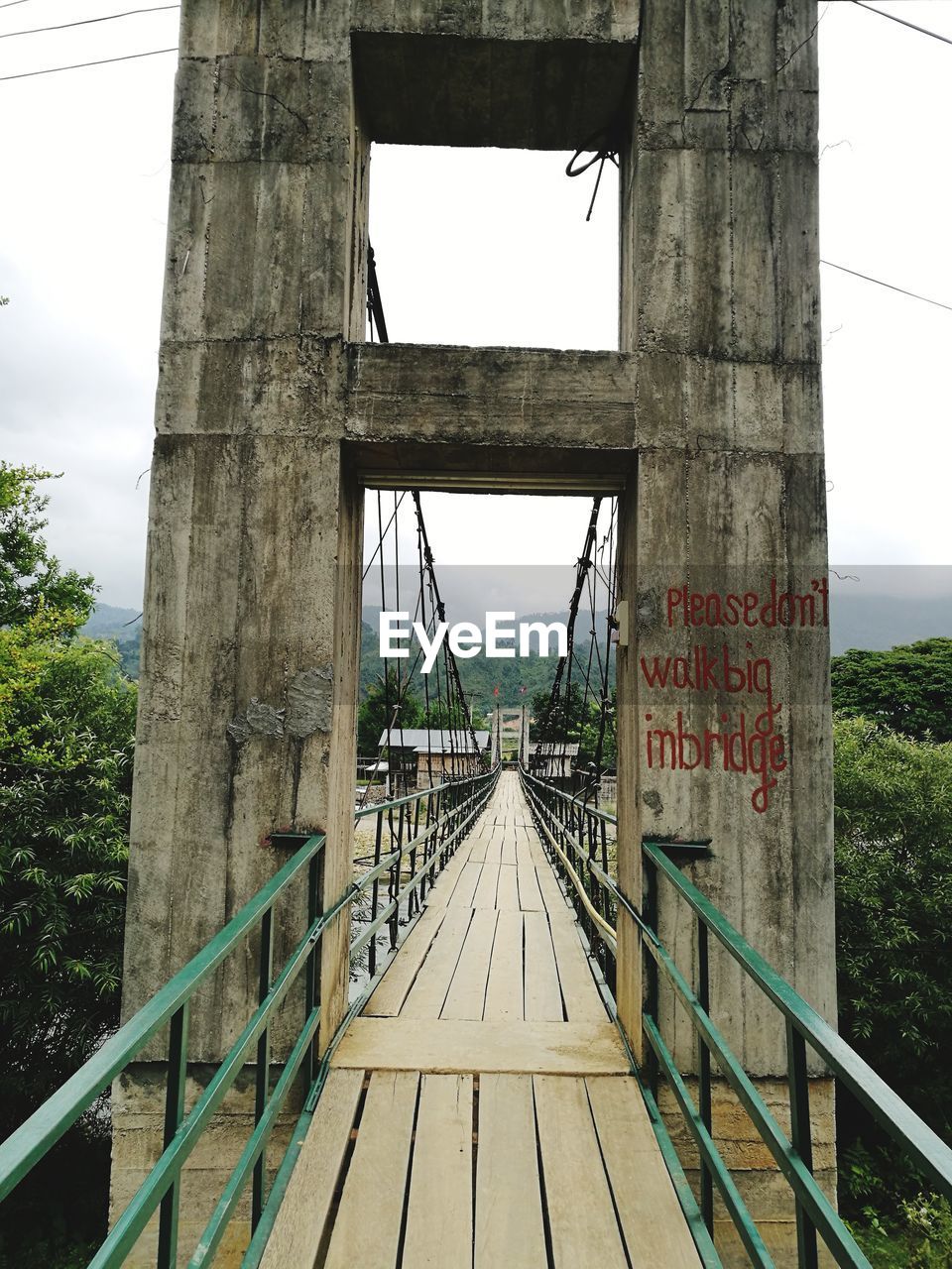 VIEW OF BRIDGE ON TREE AGAINST SKY