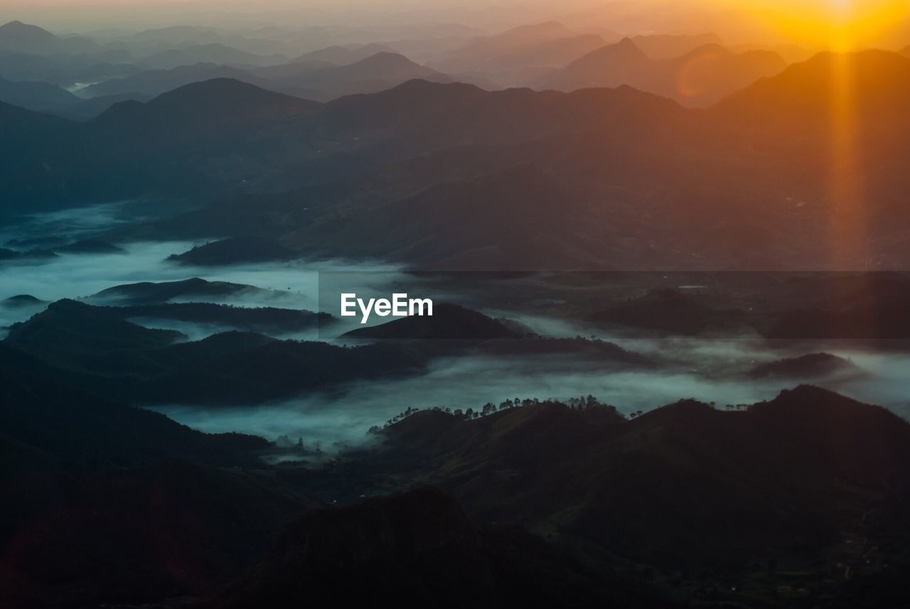 Scenic view of silhouette mountains against sky during sunset