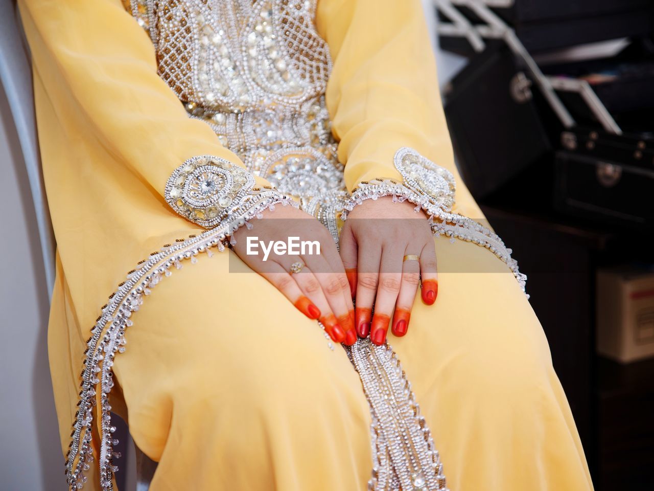 Midsection of bride sitting during wedding ceremony