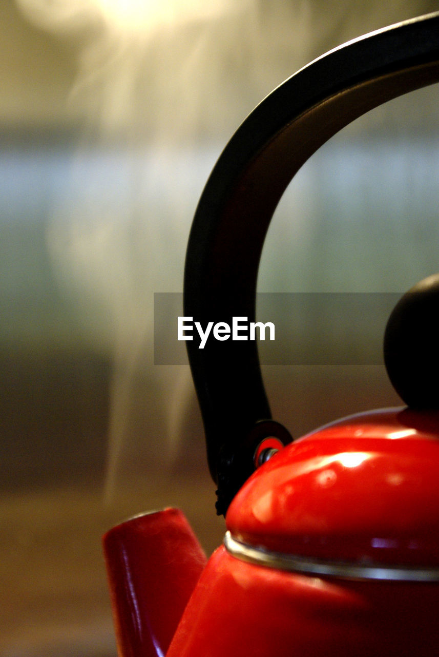 Close-up of red kettle in kitchen at home