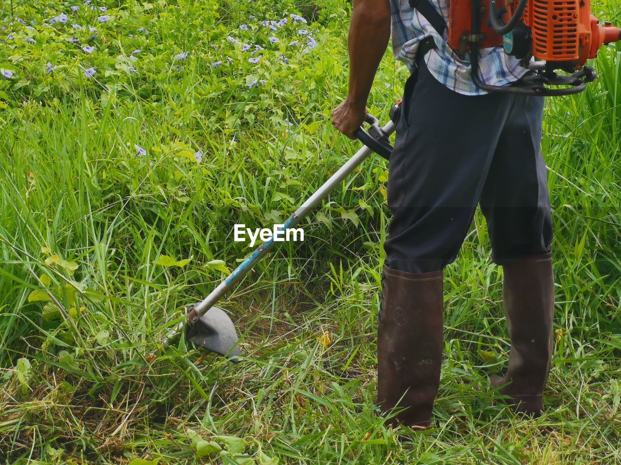 LOW SECTION OF MAN STANDING ON FIELD