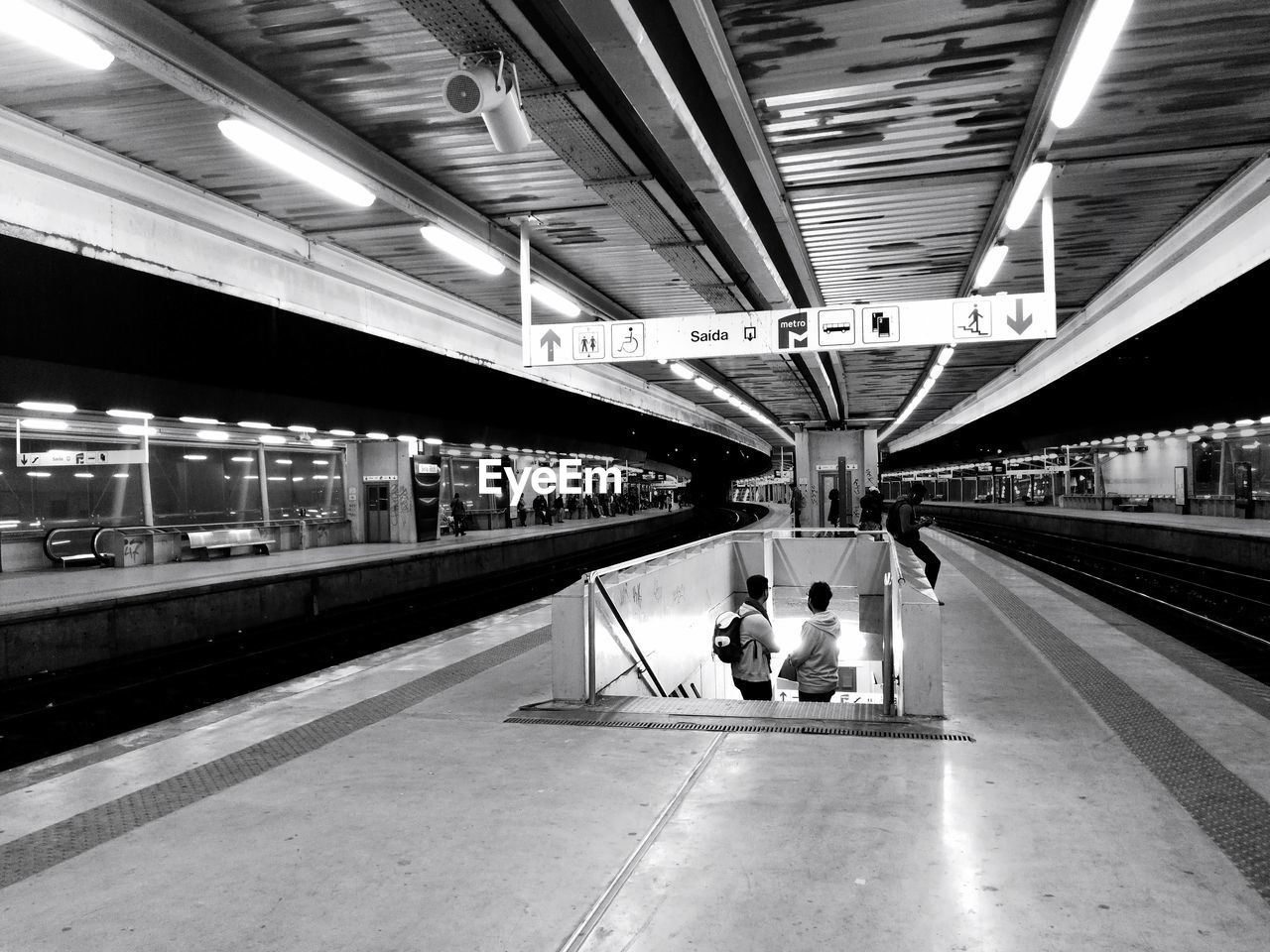 PEOPLE ON RAILROAD STATION PLATFORM