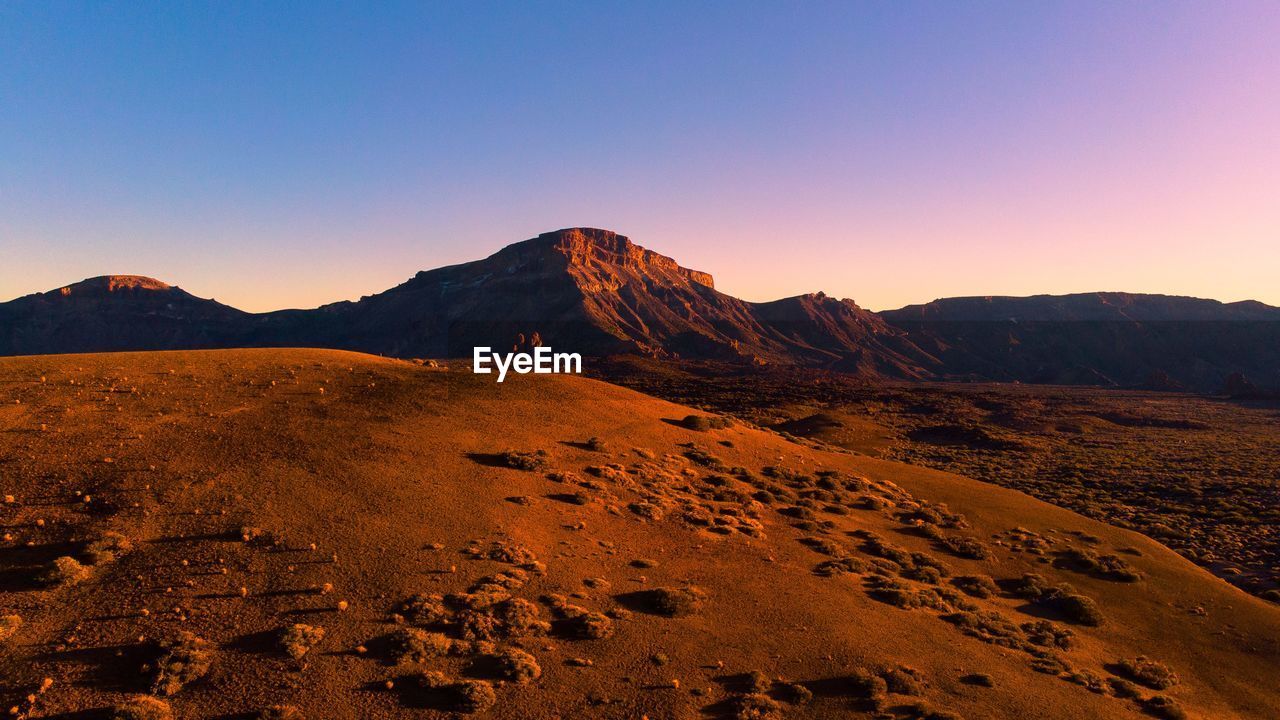 SCENIC VIEW OF ARID LANDSCAPE AGAINST CLEAR SKY