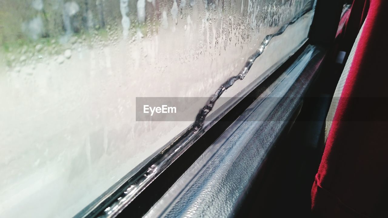 Close-up of wet bus window