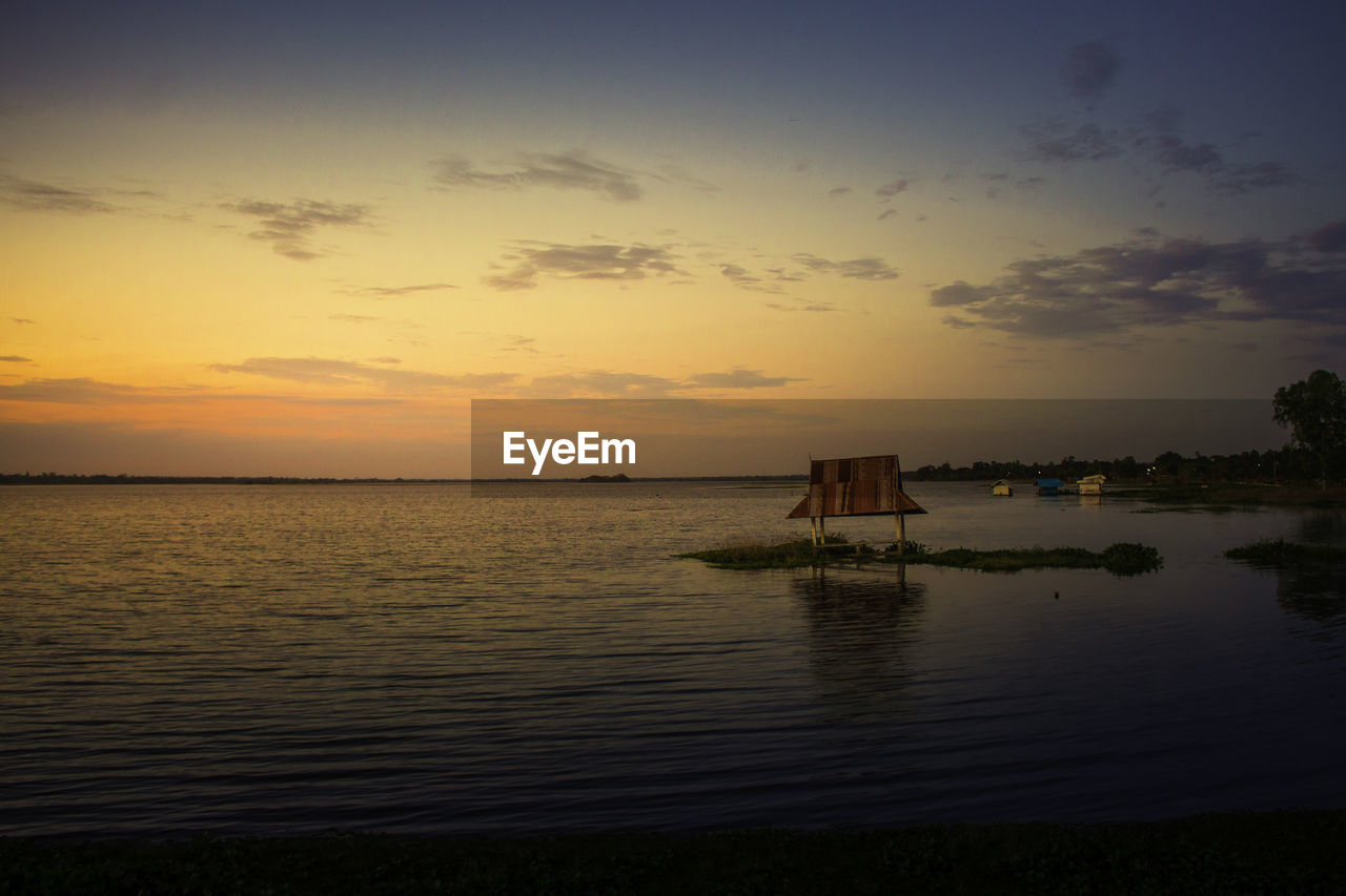 Scenic view of sea against sky at sunset