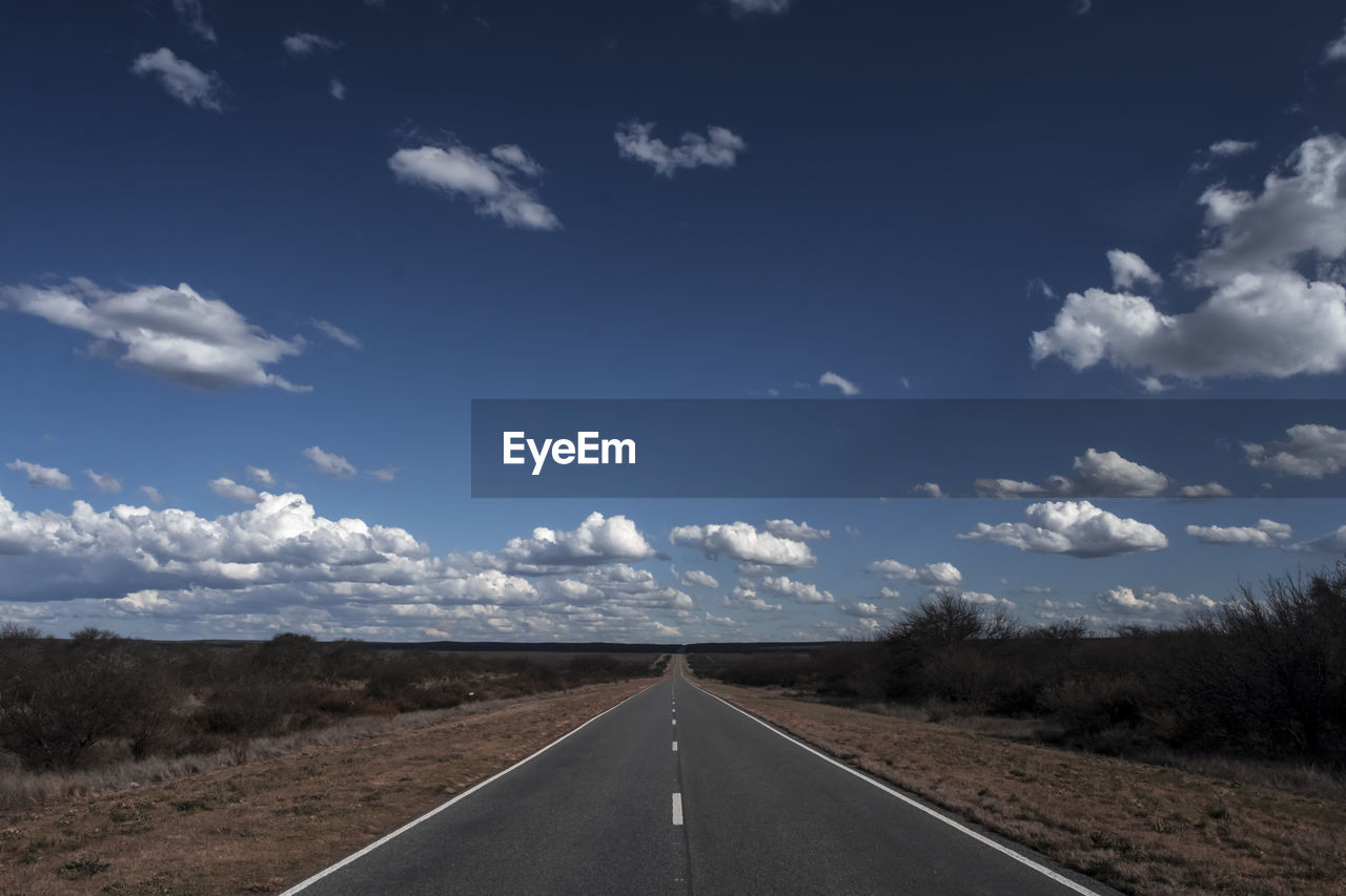 empty road against cloudy sky