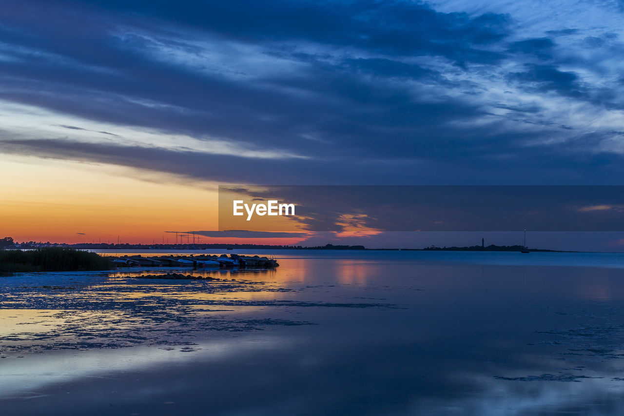 Scenic view of sea against sky at sunset