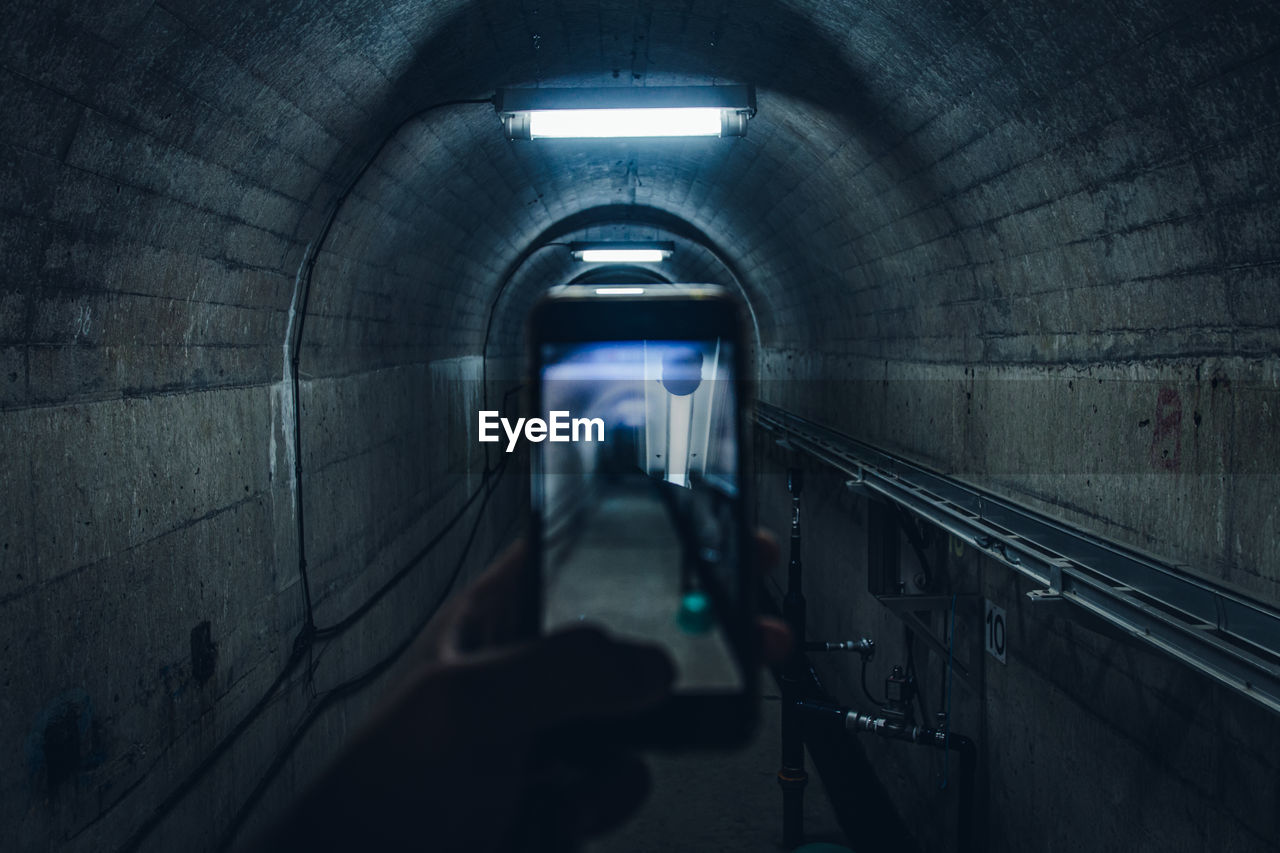 Man in  tunnel and shooting photos