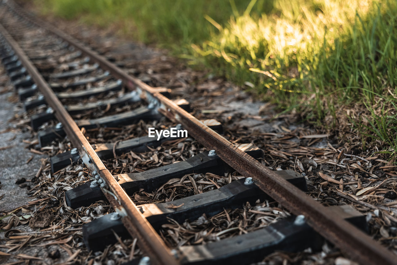 CLOSE-UP OF RAILROAD TRACK AMIDST FIELD