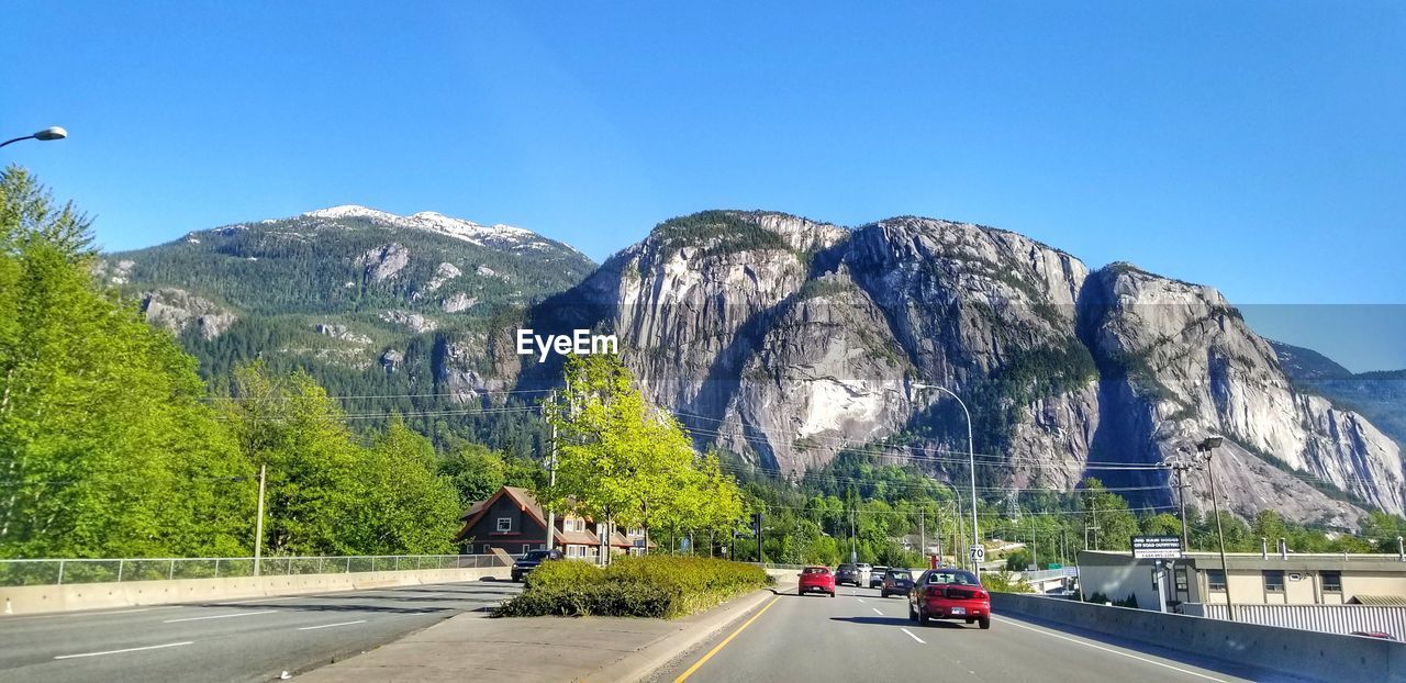 VIEW OF MOUNTAIN ROAD AGAINST BLUE SKY