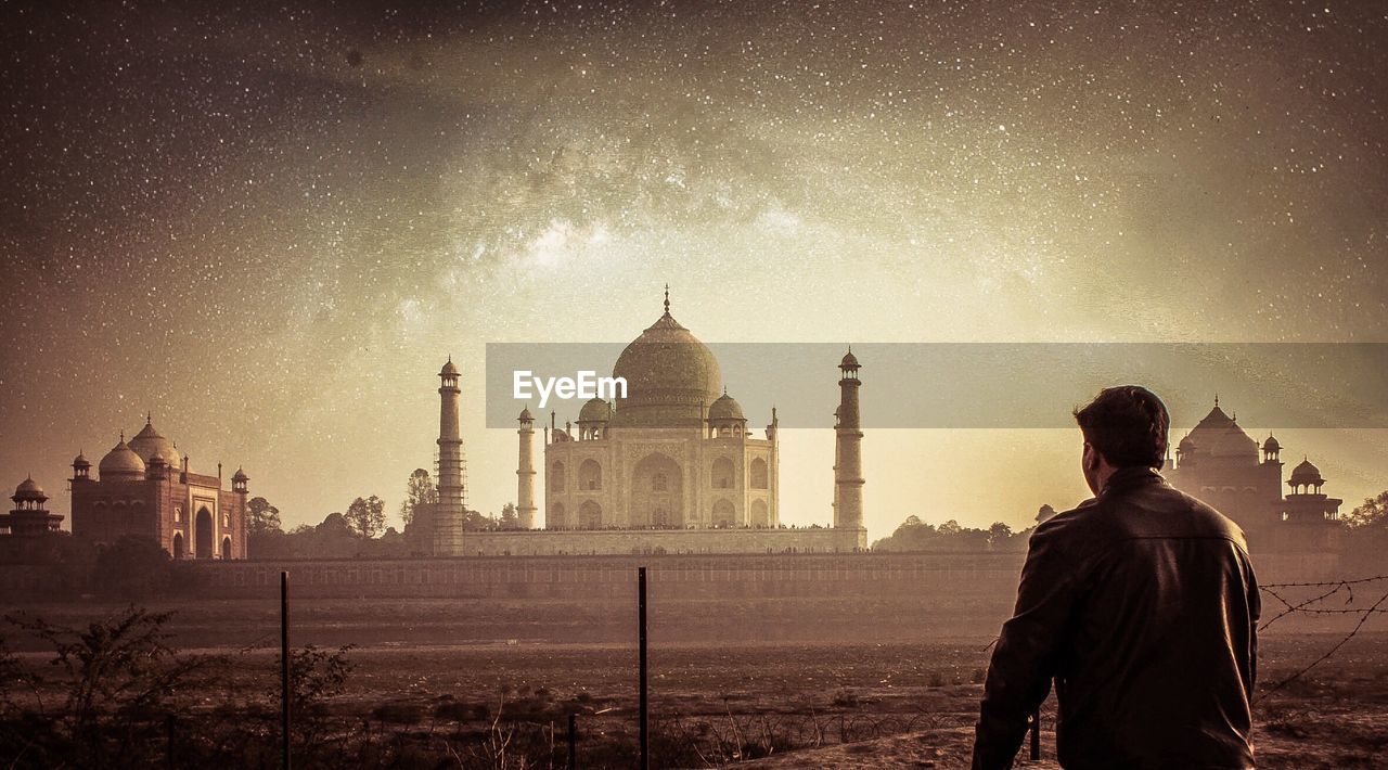 Rear view of man standing at taj mahal