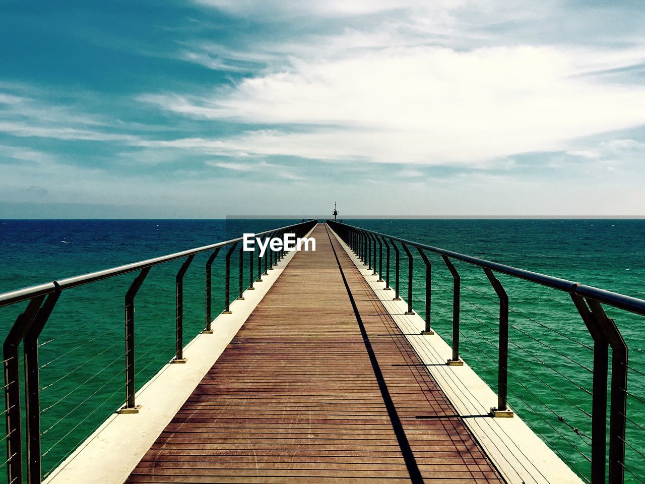 Pier over sea against sky