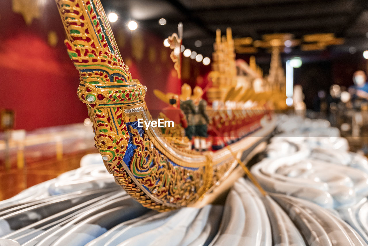 Colorful miniature boat with carved design made by wood on table