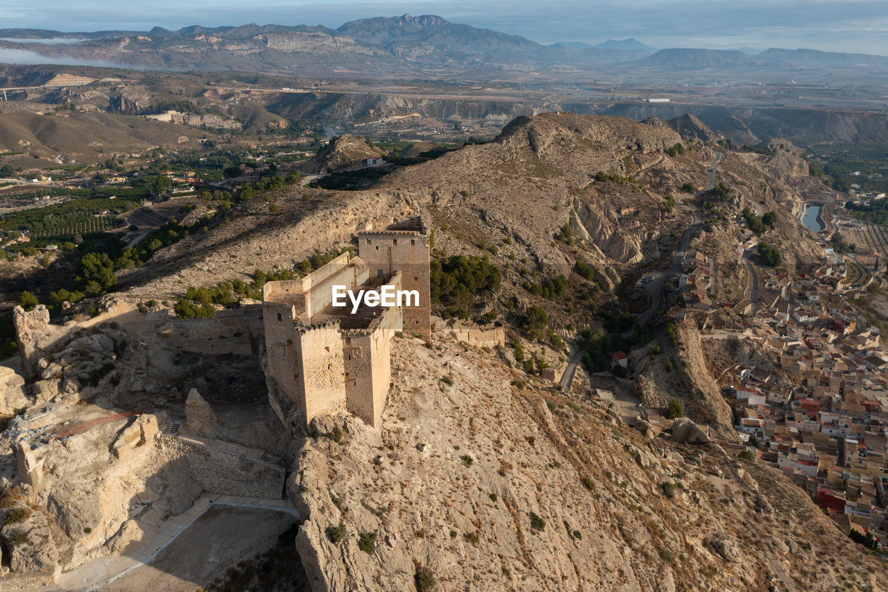 architecture, environment, landscape, history, nature, the past, ancient history, travel destinations, aerial photography, scenics - nature, ancient, mountain, built structure, high angle view, ruins, travel, land, geology, building exterior, sky, no people, outdoors, building, tourism, rock, city, day, mountain range, terrain, ancient civilization, beauty in nature, religion, aerial view, tranquility