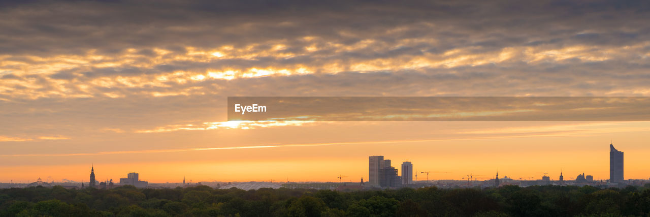 Scenic view of buildings against sky during sunset