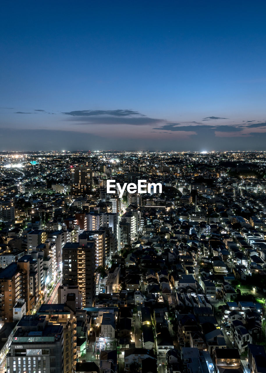 HIGH ANGLE VIEW OF ILLUMINATED BUILDINGS AGAINST SKY