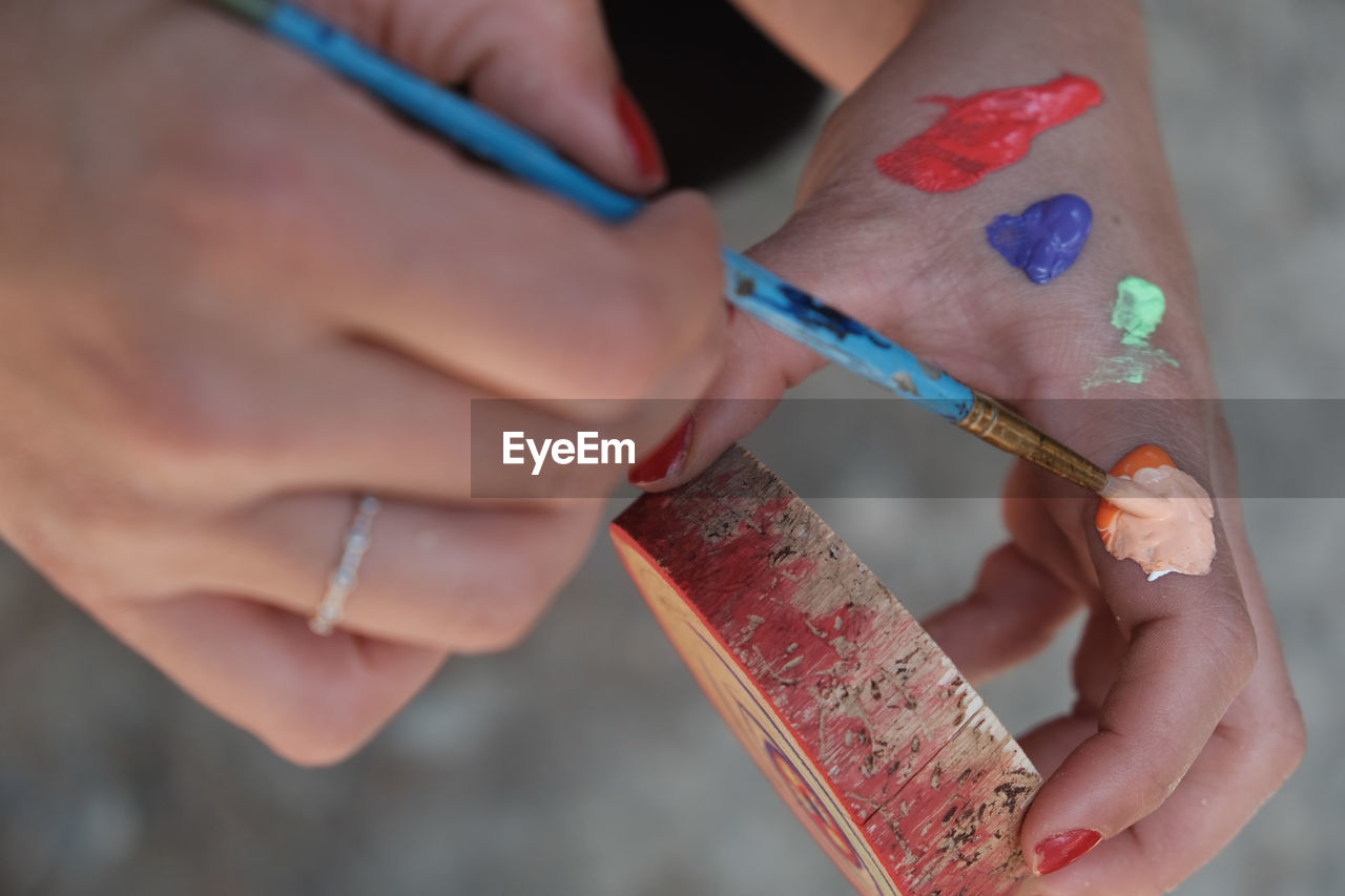 Broken hand of woman painting wood