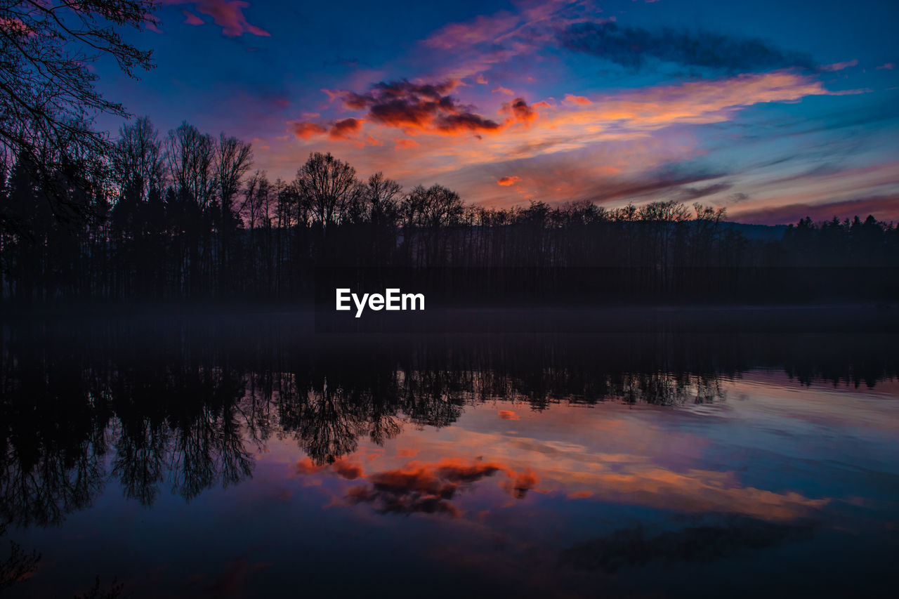 Scenic view of lake against sky during sunset