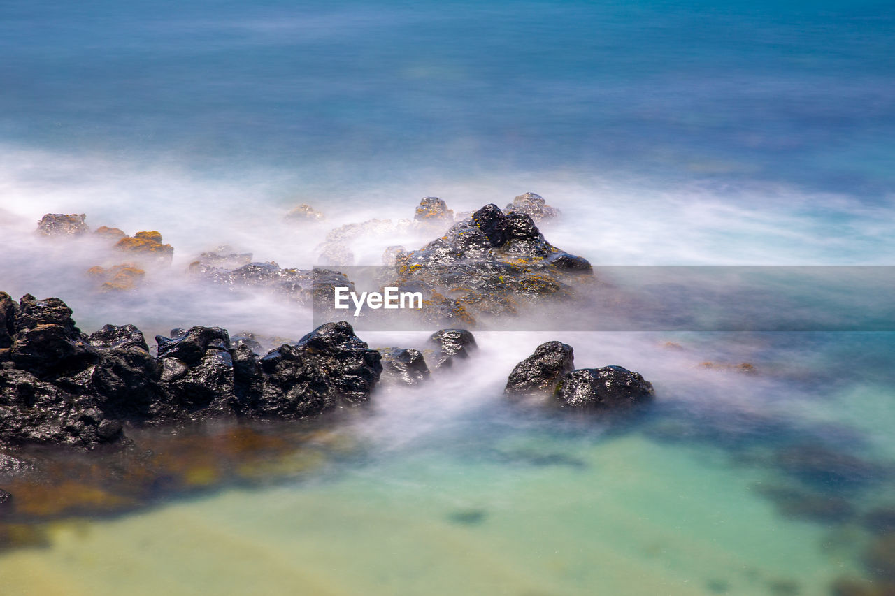 High angle view of rocks in sea