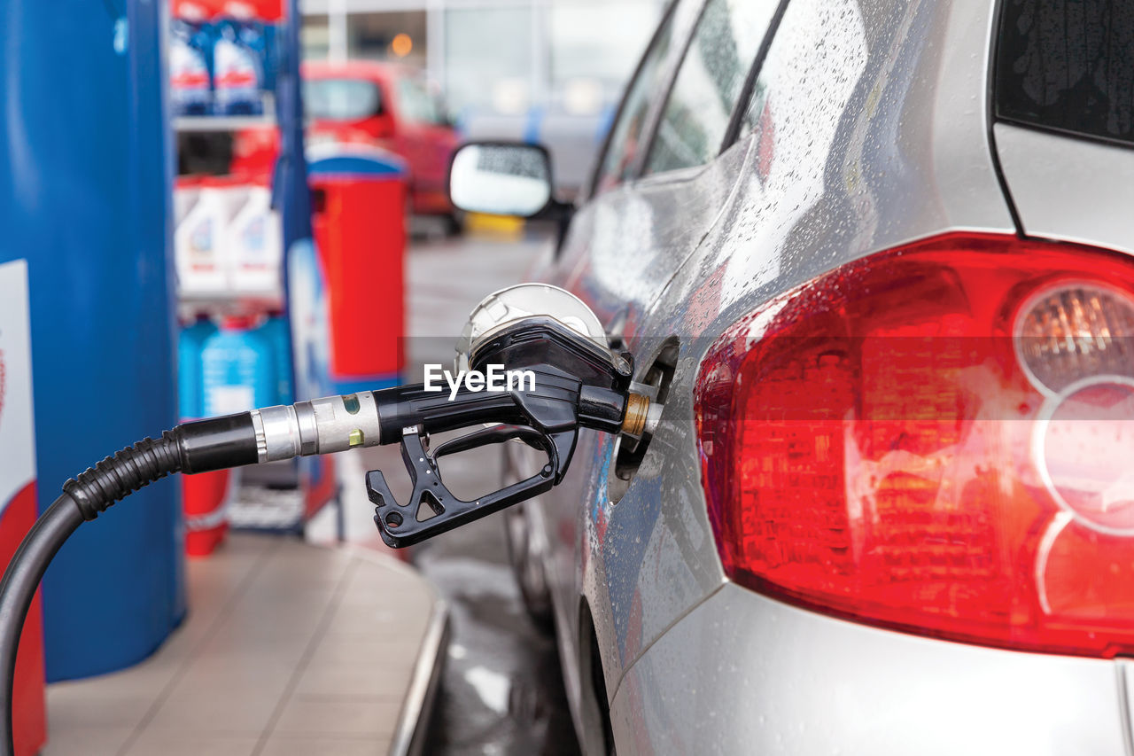 Fill up a car with petrol or diesel fuel at gas station