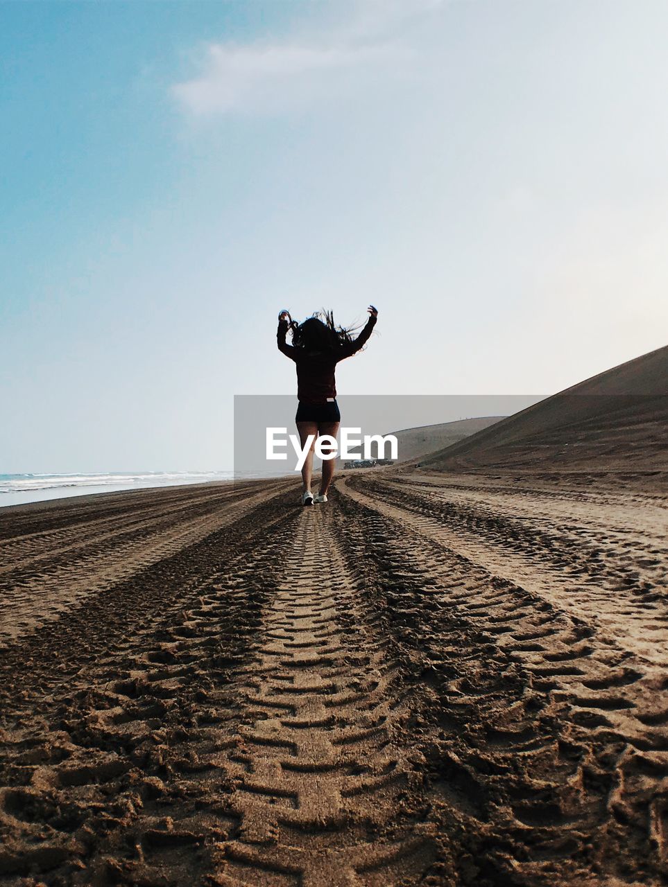 FULL LENGTH REAR VIEW OF MAN AGAINST CLEAR SKY