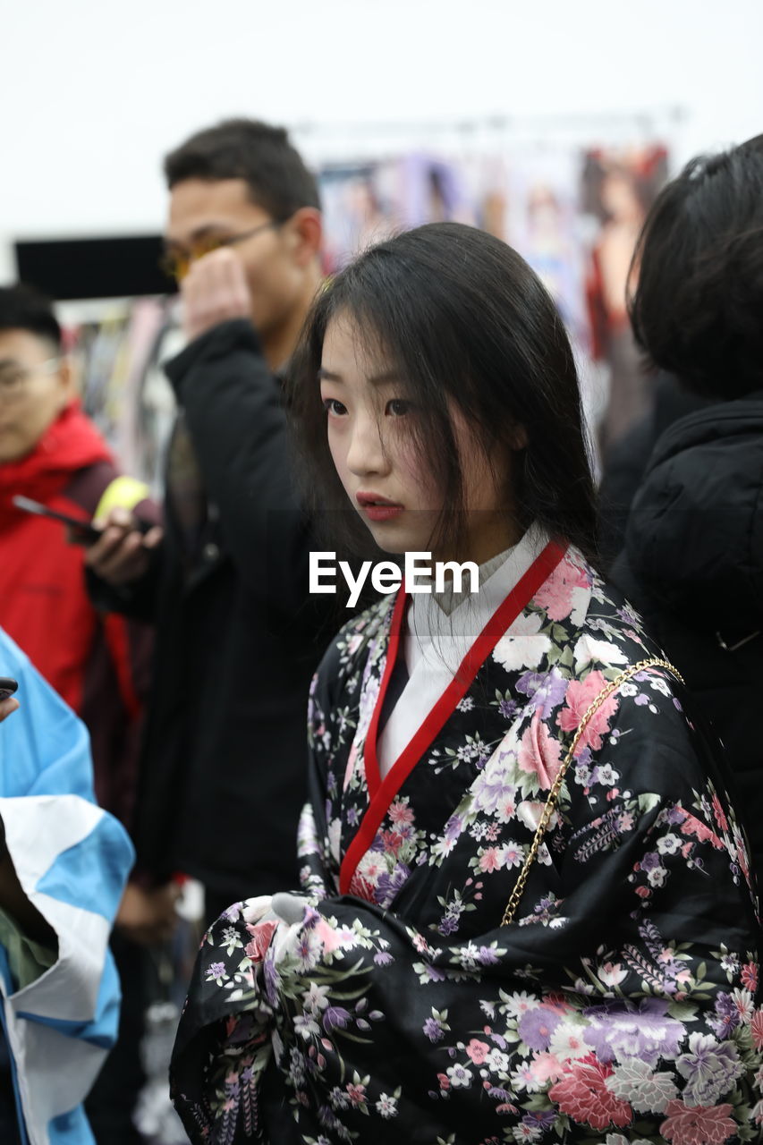 Woman wearing kimono while standing in city