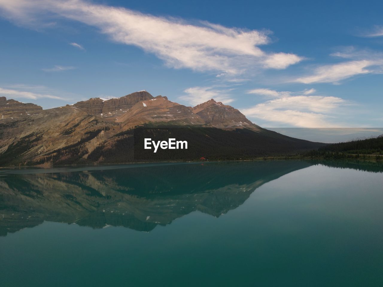 mountain, water, lake, scenics - nature, reflection, environment, sky, landscape, beauty in nature, nature, mountain range, cloud, land, no people, tranquility, travel destinations, tranquil scene, reservoir, travel, highland, outdoors, blue, non-urban scene, tourism, day, mountain peak, idyllic, wilderness