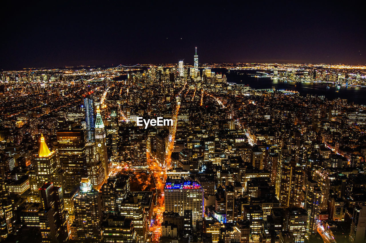 Aerial view of city lit up at night