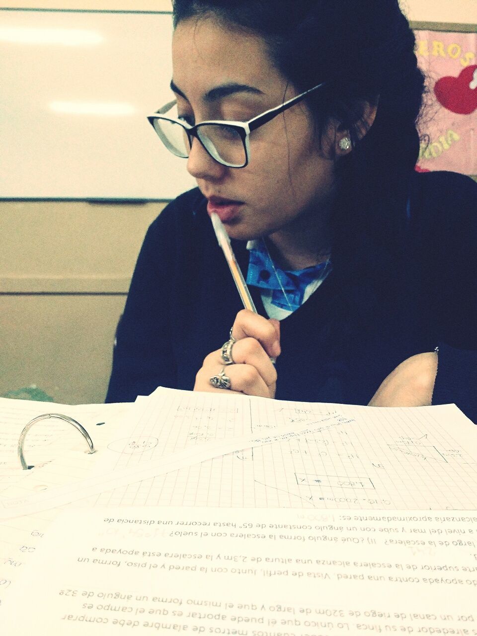 Close-up of teenage girl studying at desk in school