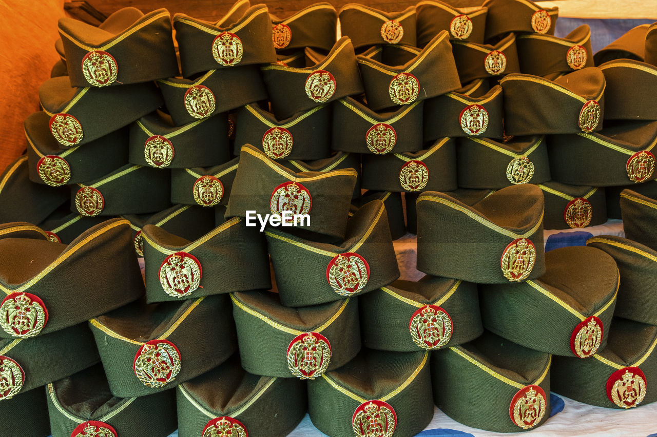 Full frame shot of stacked uniform caps