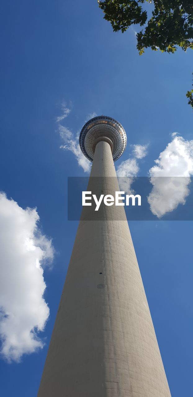 Low angle view of tower against cloudy sky