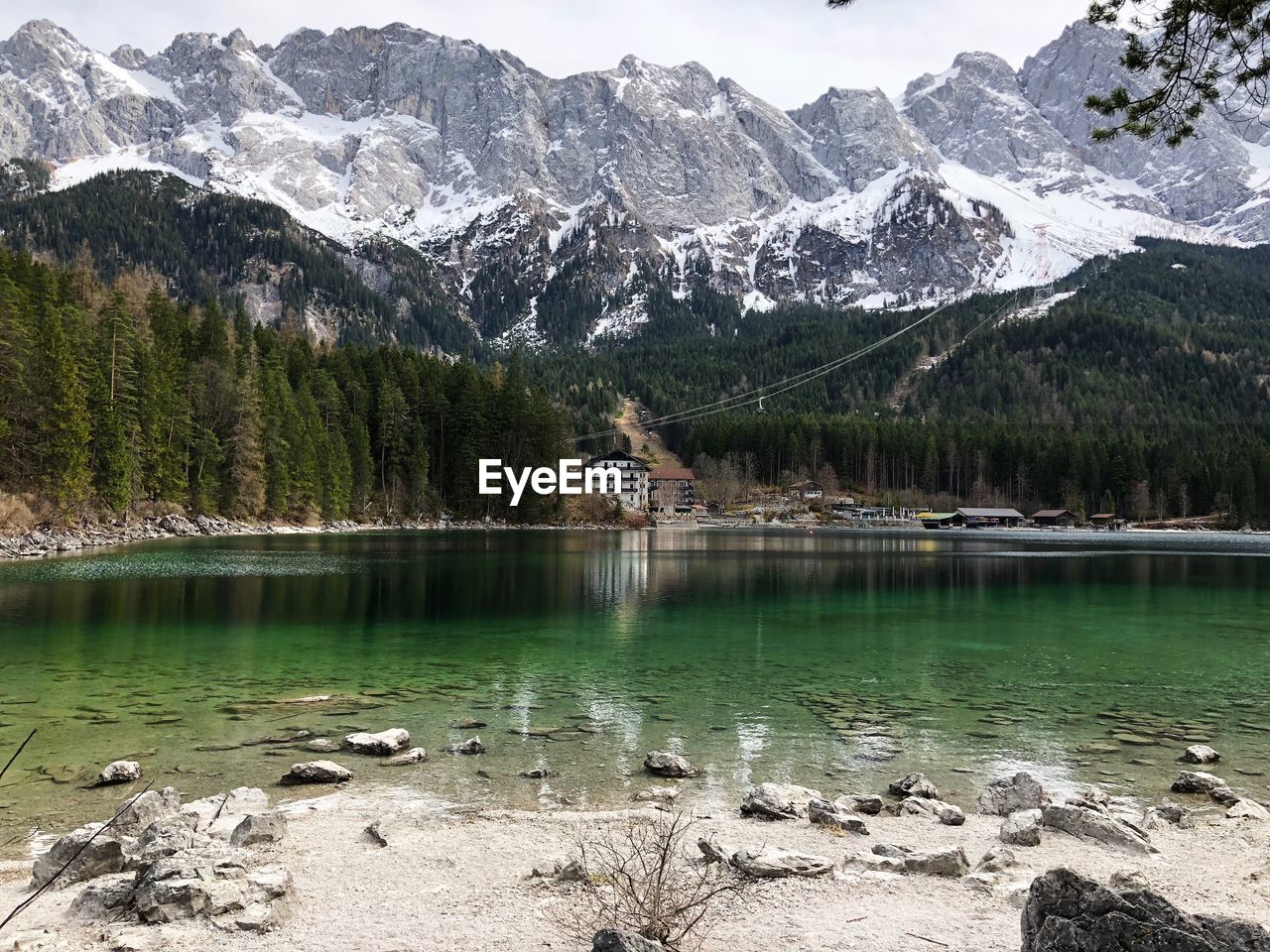 Scenic view of lake by snowcapped mountains