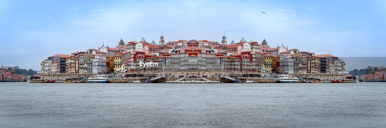 VIEW OF BUILDINGS BY SEA AGAINST SKY