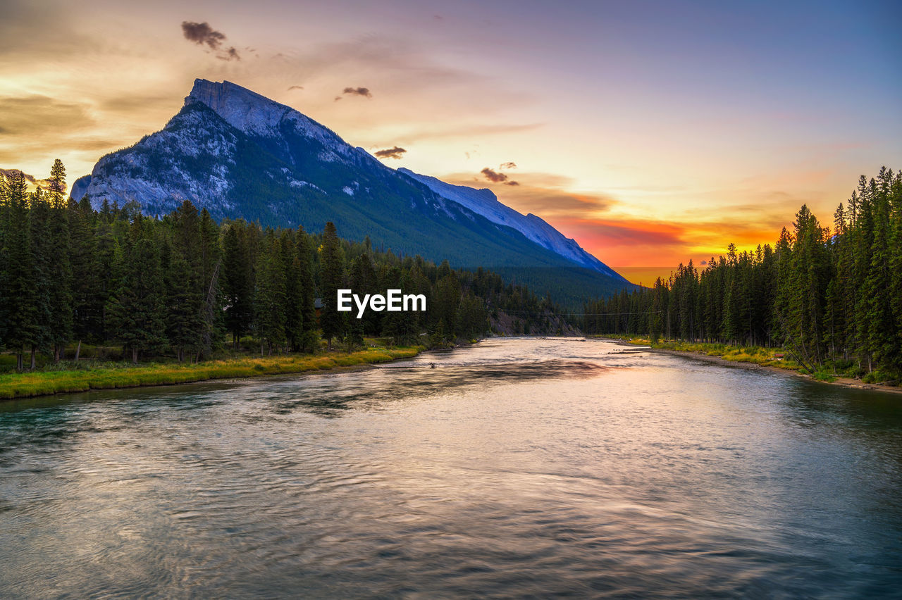 scenic view of river against sky during sunset