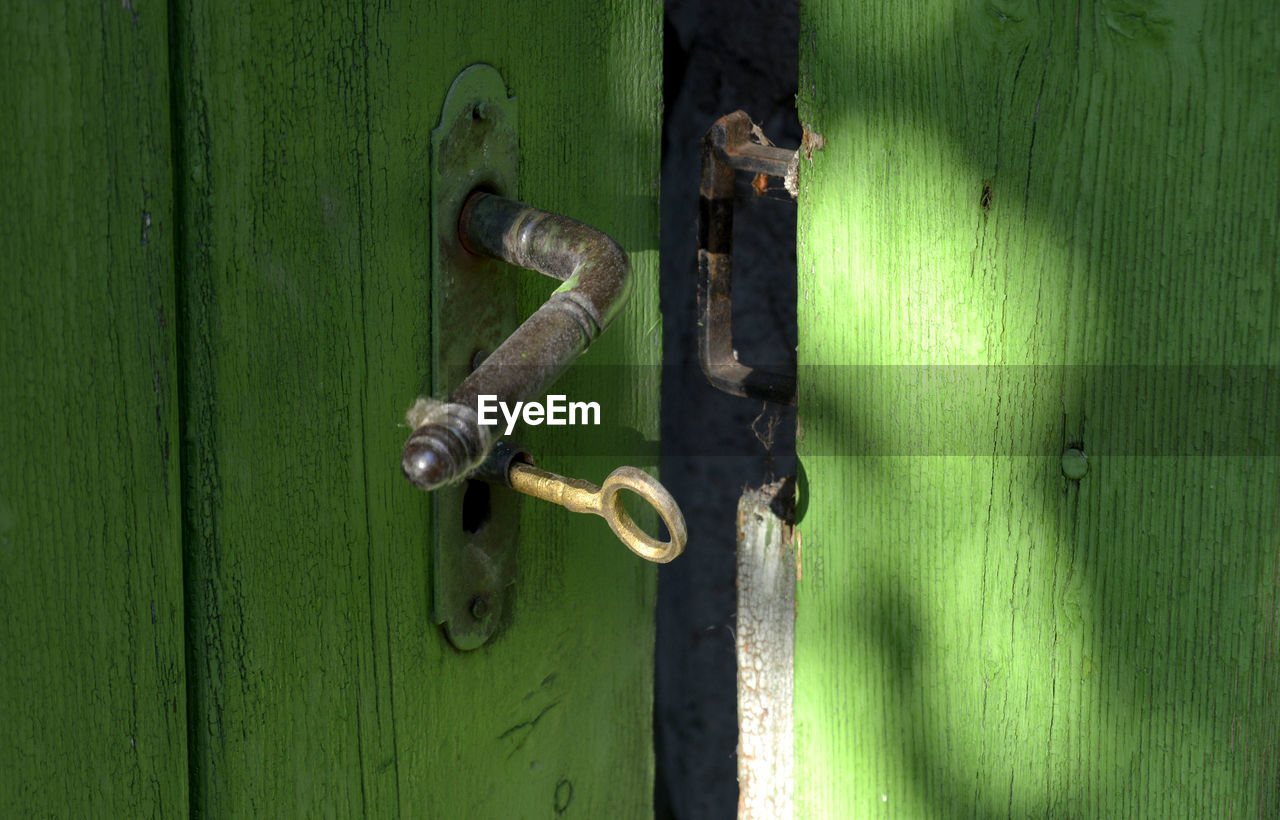 Close-up of key in closed door