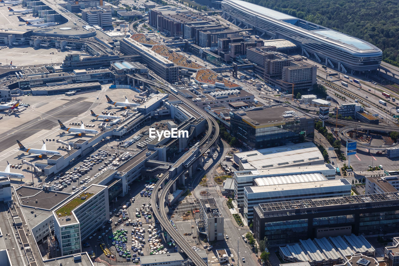 HIGH ANGLE VIEW OF STREET AMIDST BUILDINGS