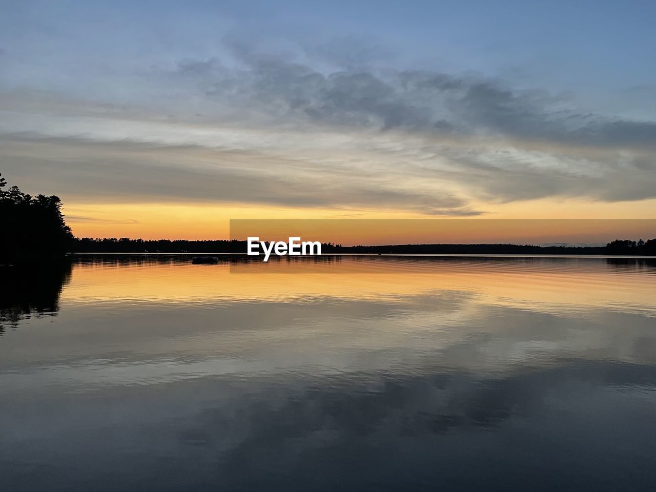 water, sky, reflection, cloud, beauty in nature, sunset, tranquility, scenics - nature, nature, tranquil scene, dawn, lake, no people, horizon, environment, idyllic, silhouette, landscape, outdoors, tree, evening, standing water, non-urban scene, afterglow, sunlight, dramatic sky, orange color, beach