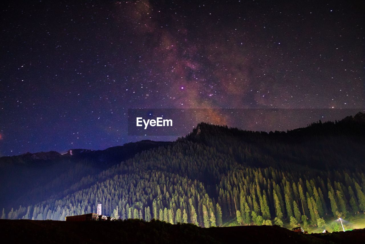 Scenic view of silhouette mountains against sky at night