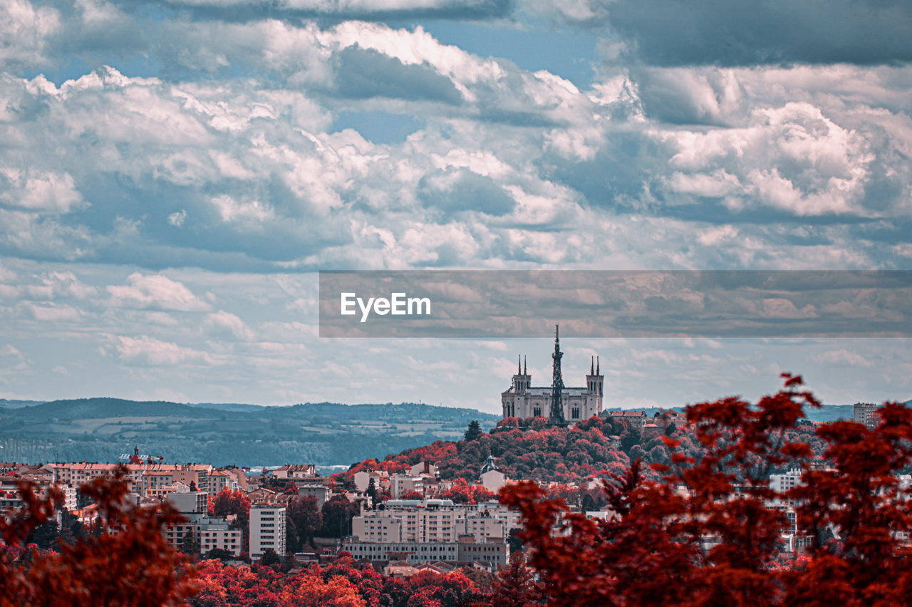 High angle view of buildings against cloudy sky